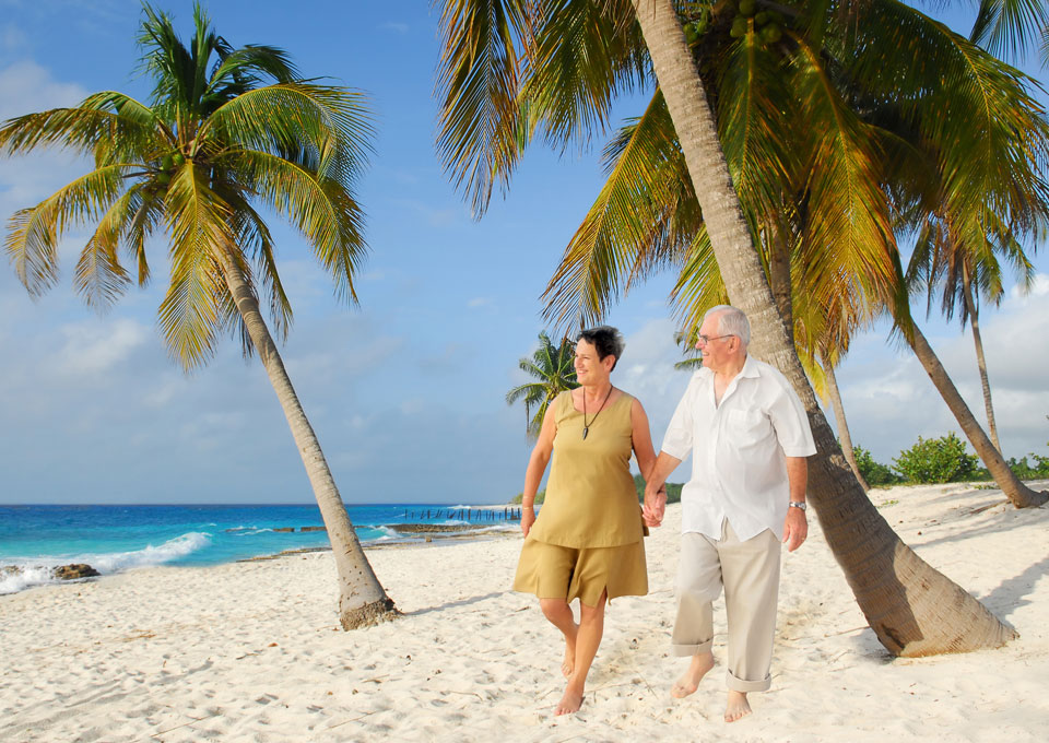 Couple on a beach holiday with travel insurance